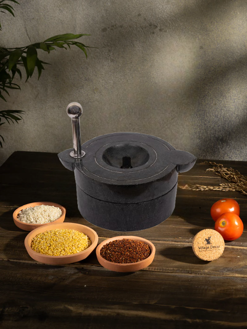 Traditional Handmade Atta Chakki placed on table surrounded by fresh ingredients.