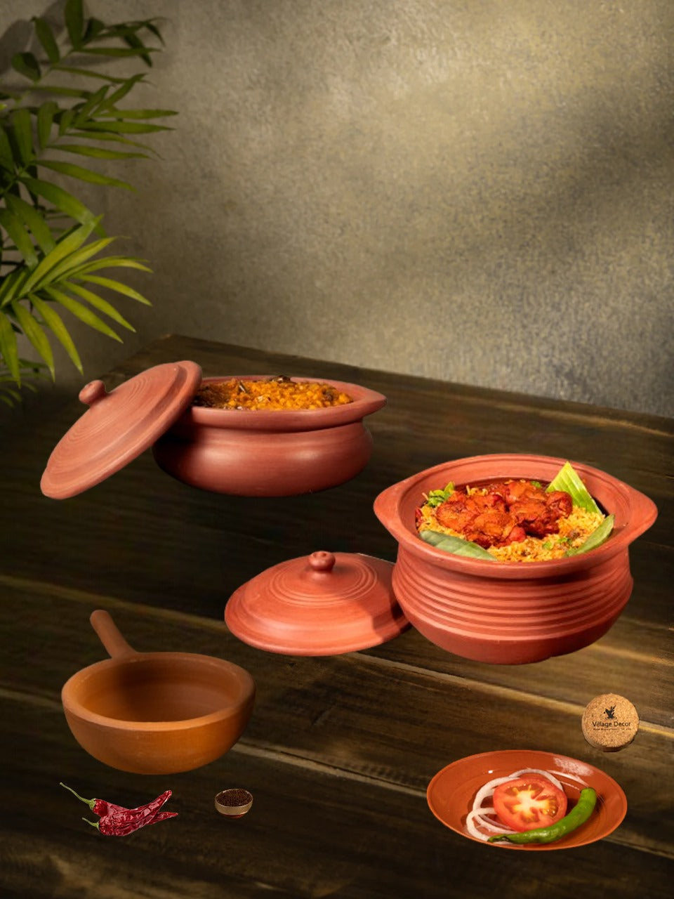 Clay cookware set with mitti ke bartan and pan placed on a wooden table, showing a homely food serving setup.