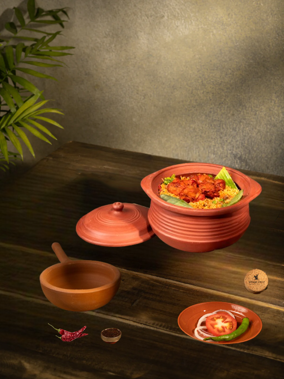 Clay cookware set with mitti ke bartan and pan placed on a wooden table, showing a homely food serving setup.