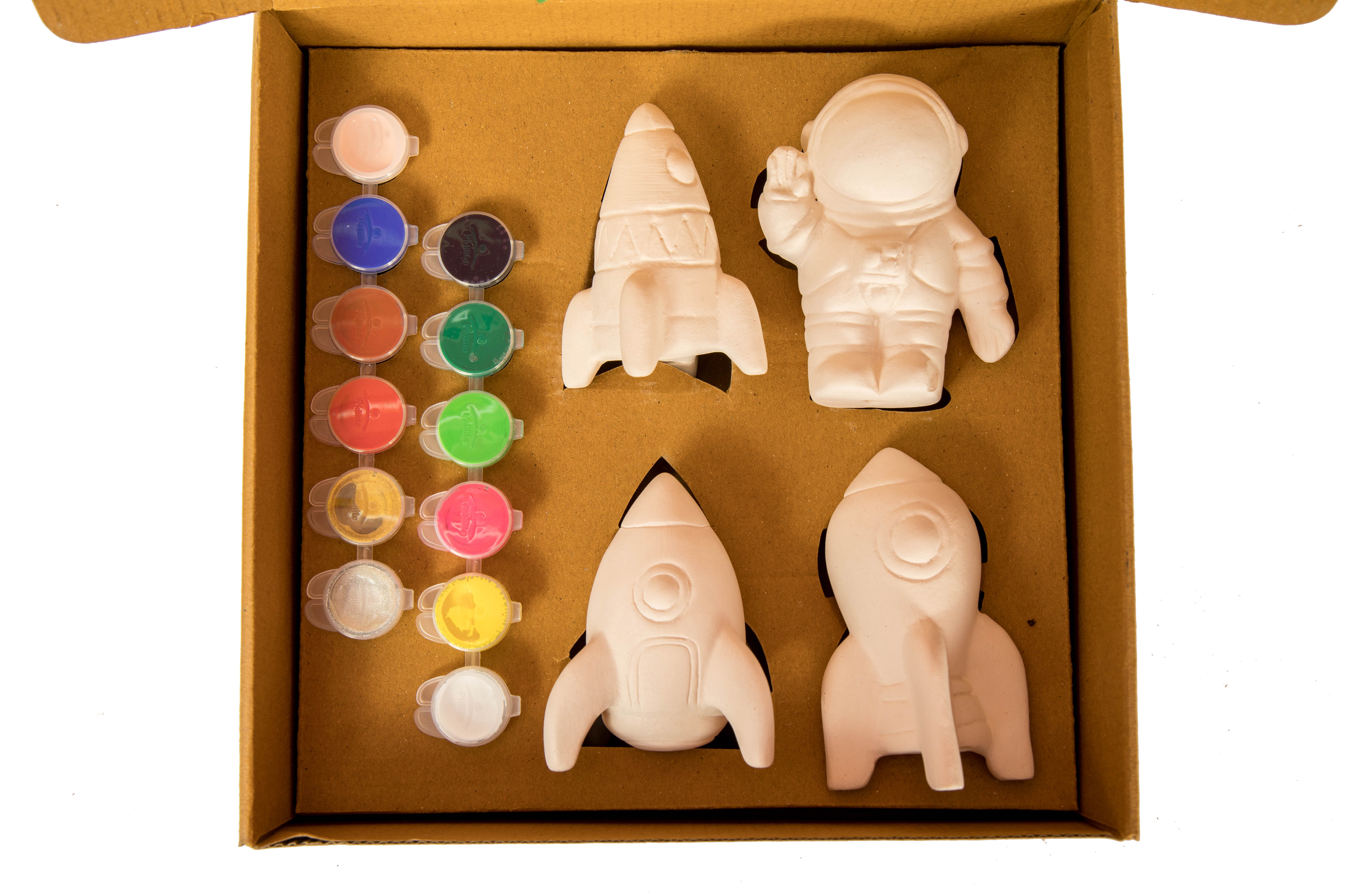 DIY space painting kit in a carton box featuring astronaut and rocket plaster models with colorful paints for kids’ creative fun.