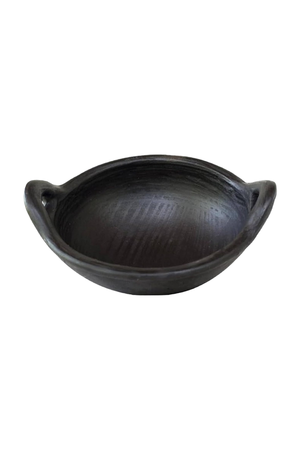 Earthen black clay kadai with twin handles, displayed on a white background — traditional handmade cookware for sauteing and more.
