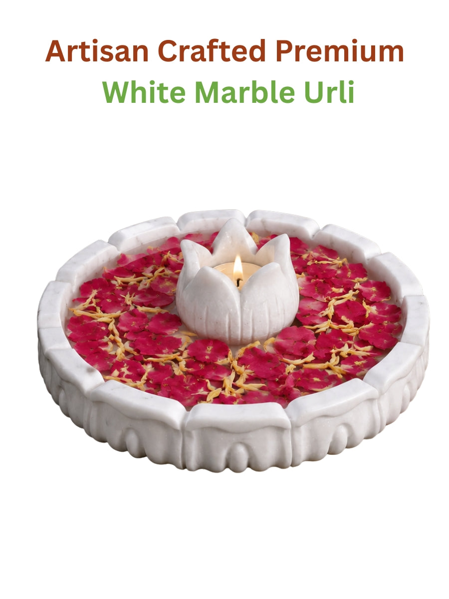Handcrafted lotus marble urli with tea light holder displayed with vibrant rose petals and a central tealight on a clean white background, showcasing its elegant lotus-inspired design.