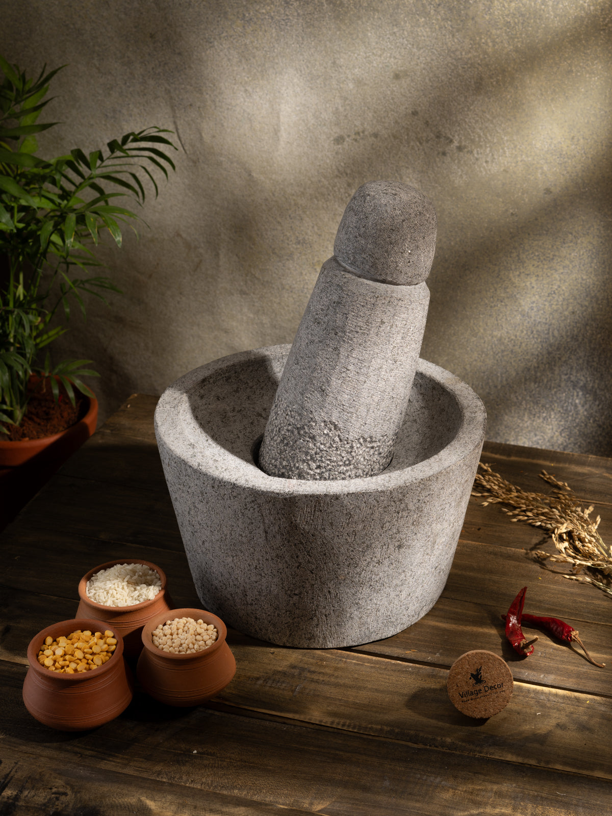 Traditional Handmade Mortar and Pestle placed on table surrounded by Lentils.