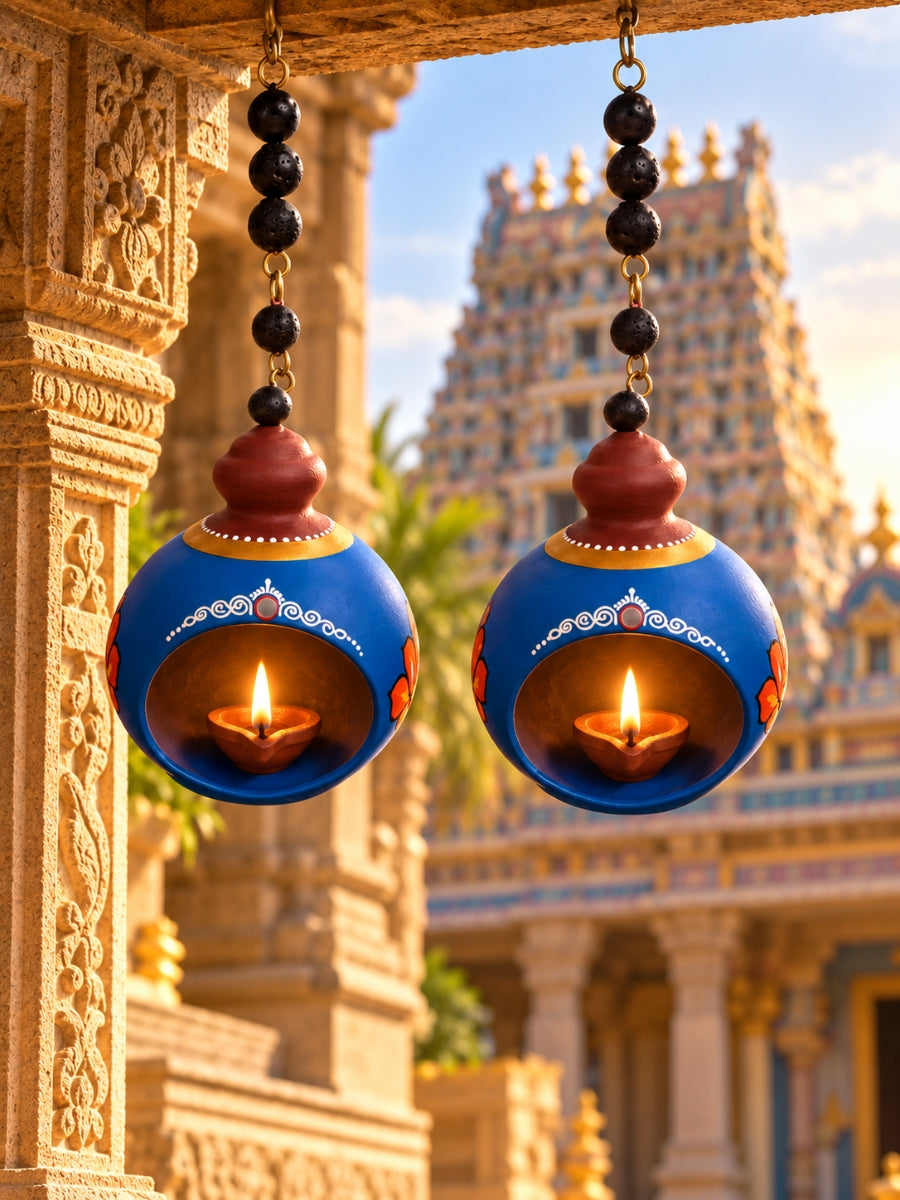 Temple blue hanging doom-shaped terracotta diya displayed in a home decor setting, featuring traditional handpainted details for pooja and festive decoration