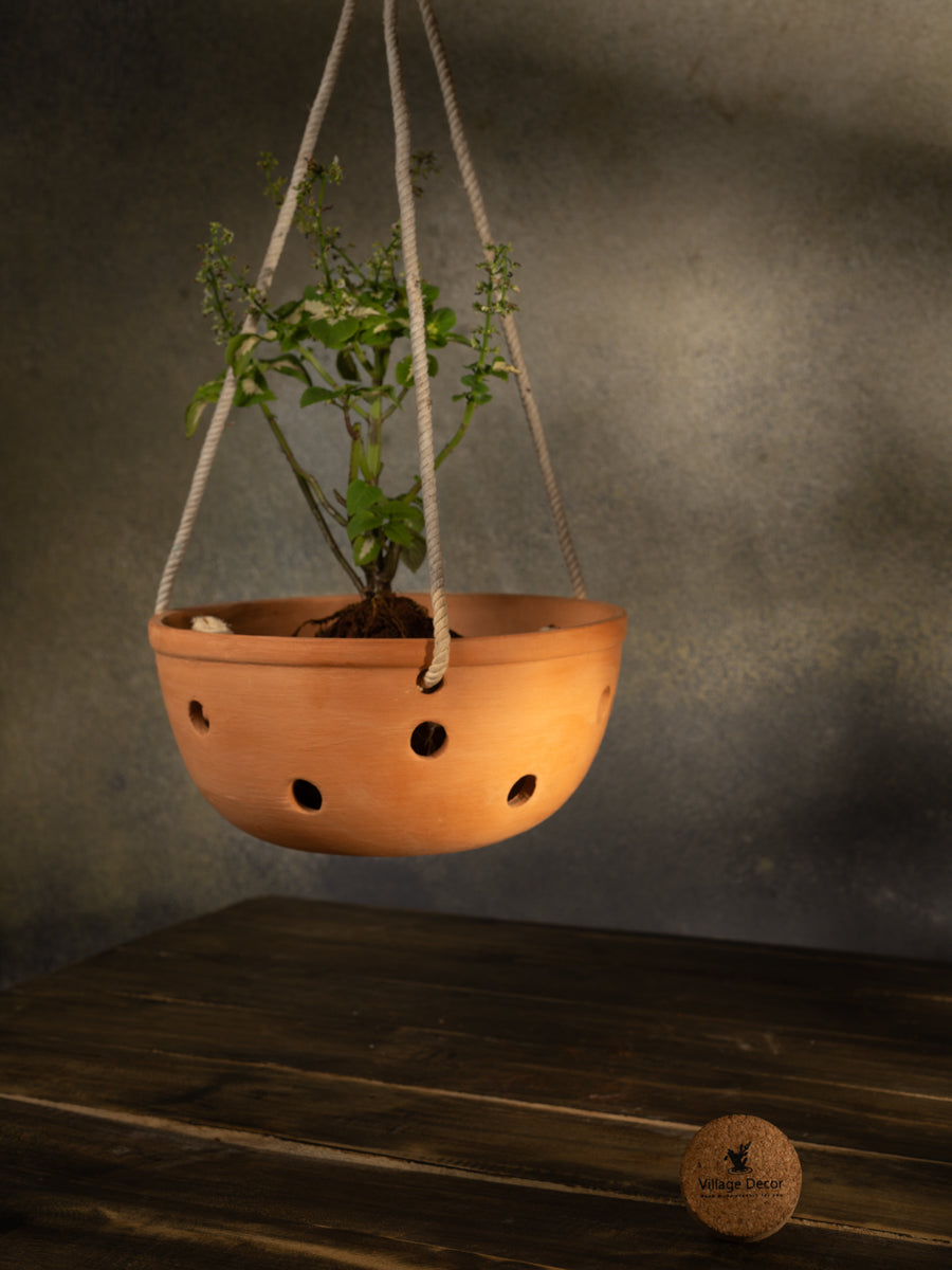 Terracotta indoor flower pot with multiple drainage holes, ideal for garden plants or as a decorative clay planter for home and office spaces.