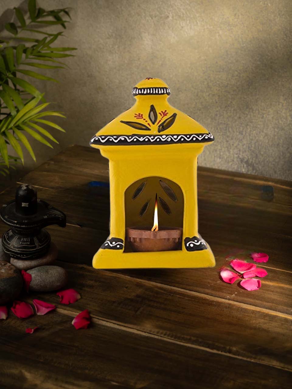 Handcrafted yellow terracotta diya in a charming hut shape, beautifully hand-painted with floral patterns, ideal for Diwali, pooja room, and ethnic home decor.