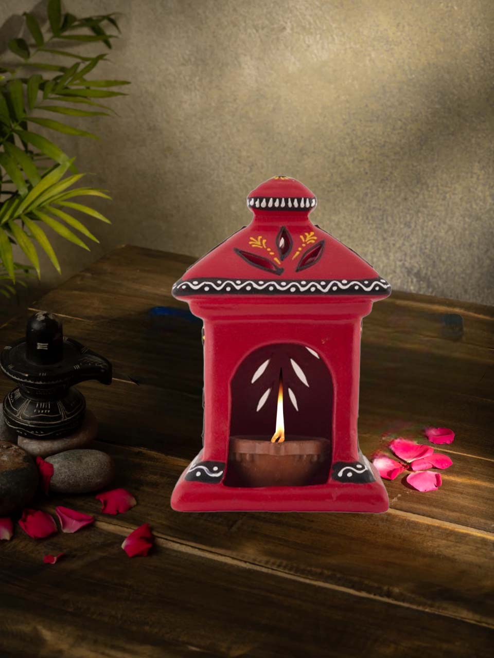 Handcrafted yellow terracotta diya in a charming hut shape, beautifully hand-painted with floral patterns, ideal for Diwali, pooja room, and ethnic home decor.