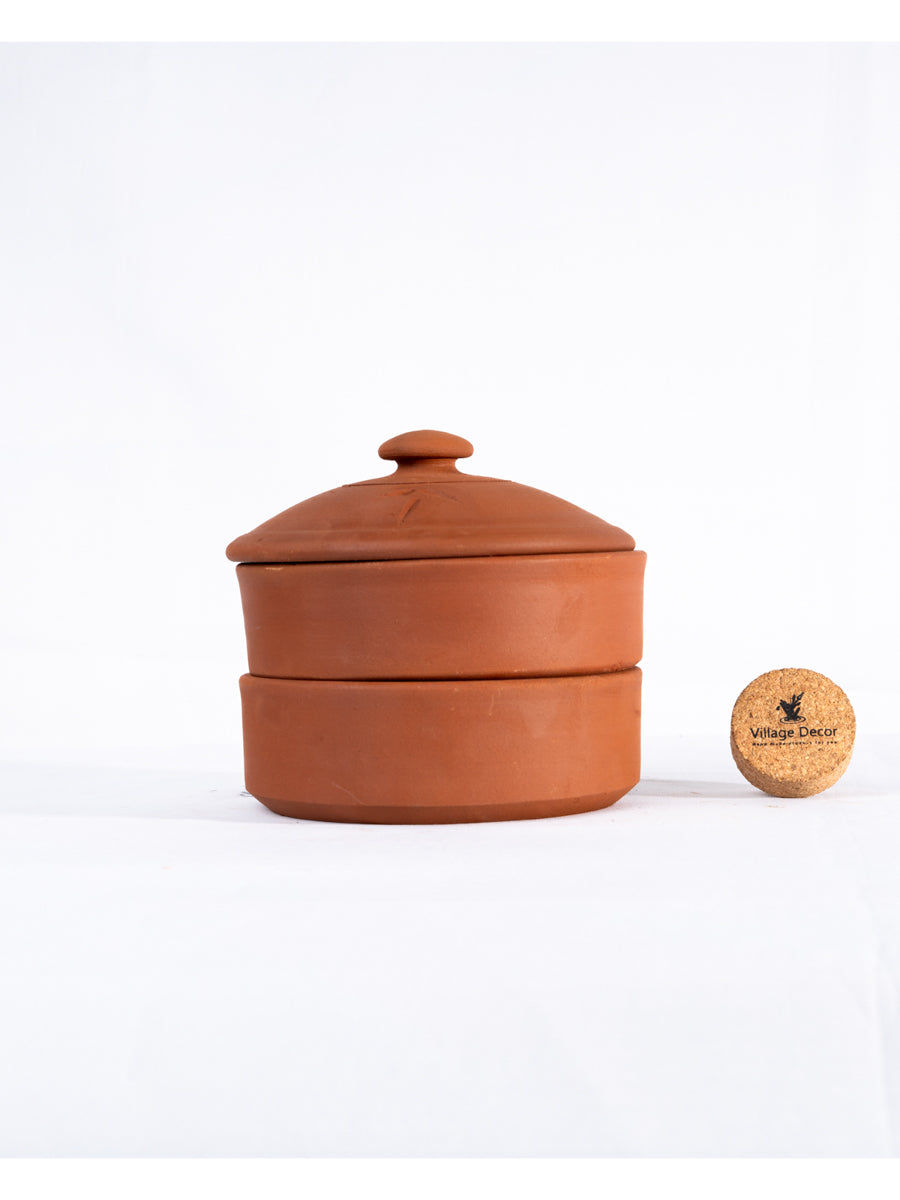 Three tier terracotta sprout maker with lid placed on a plain white background highlighting its natural clay finish and tableware purpose.