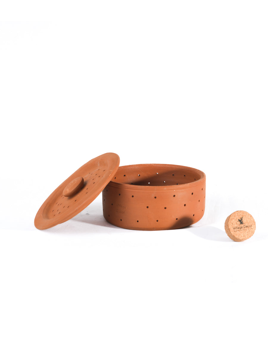 Three tier terracotta sprout maker with lid placed on a plain white background highlighting its natural clay finish and tableware purpose.