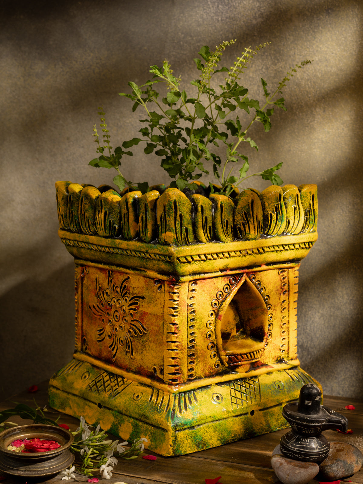 Handcrafted terracotta Tulsi Pot with Tulsi plant in traditional Vrindavan style, placed in a pooja setup with natural lighting and sacred decor.