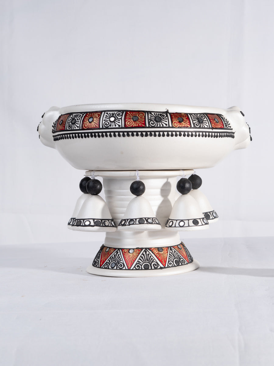 Top view of a colorful handpainted terracotta  urli with floral art, placed on a white background, ideal for festive decor or pooja setups.