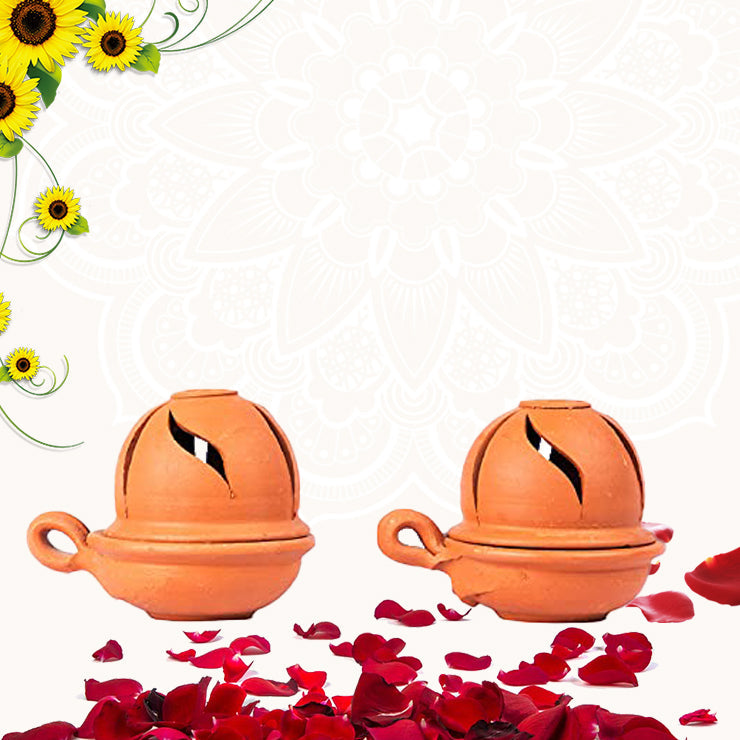 Terracotta diyas with lids displayed on a floral festive background, surrounded by rose petals and sunflower decorations — ideal for Diwali or pooja decor.