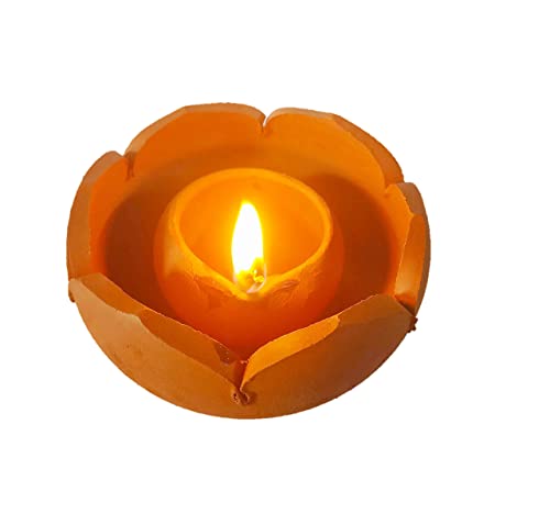 Terracotta lotus-shaped diya with a burning flame, glowing warmly against a white background.