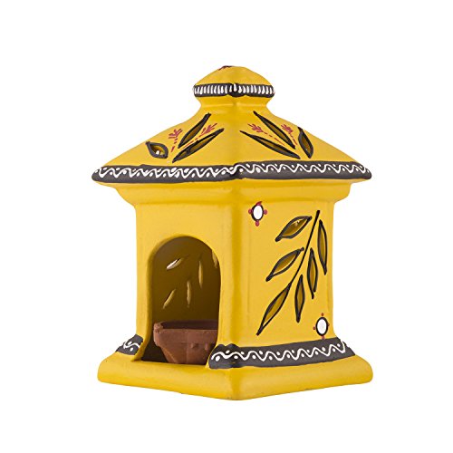 Side view of a yellow terracotta hut-shaped oil lamp with hand-painted floral and leaf designs, featuring a small clay diya inside.