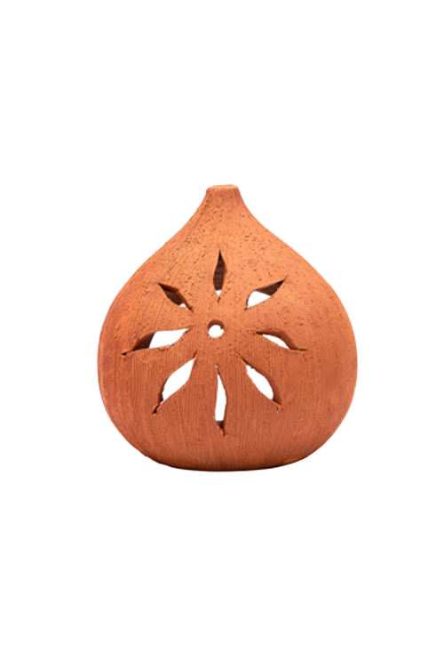 Backside view of coconut-shaped terracotta diya with star-like cutout pattern, handcrafted for traditional lighting and rustic home decor.
