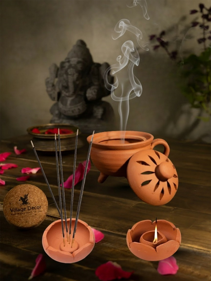Lifestyle view of everyday pooja essentials combo with clay lotus lamp, incense holder, and agarbatti stand in a traditional home worship setup.