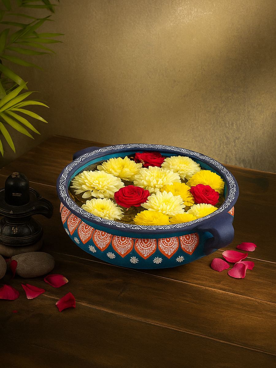 Handpainted terracotta urli bowl with an 8-inch diameter, styled with floating candles and flowers, ideal for festive decorations, floral arrangements, and traditional home decor.