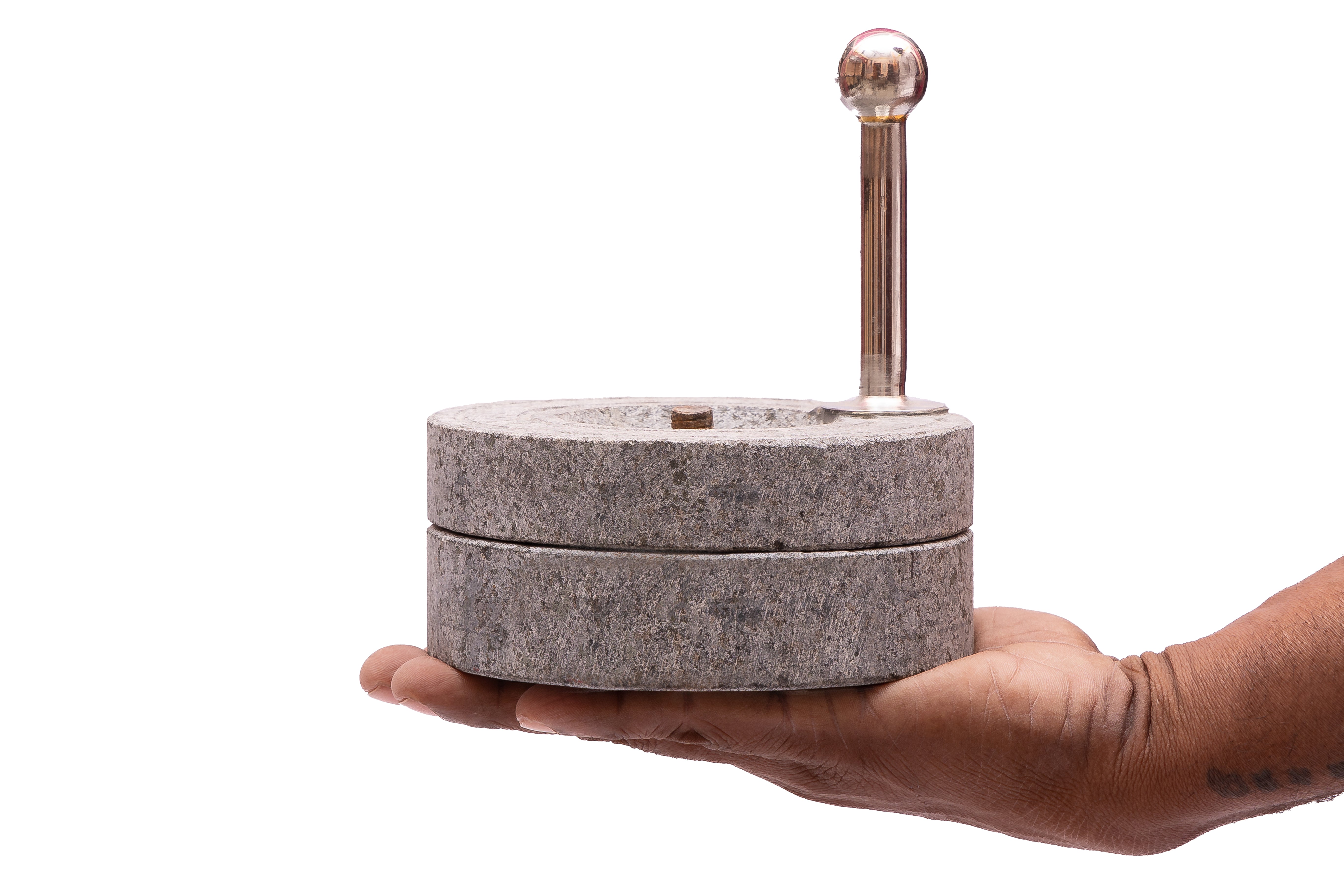Miniature atta chakki placed on hand, traditional grinding model for kids’ play and educational learning.