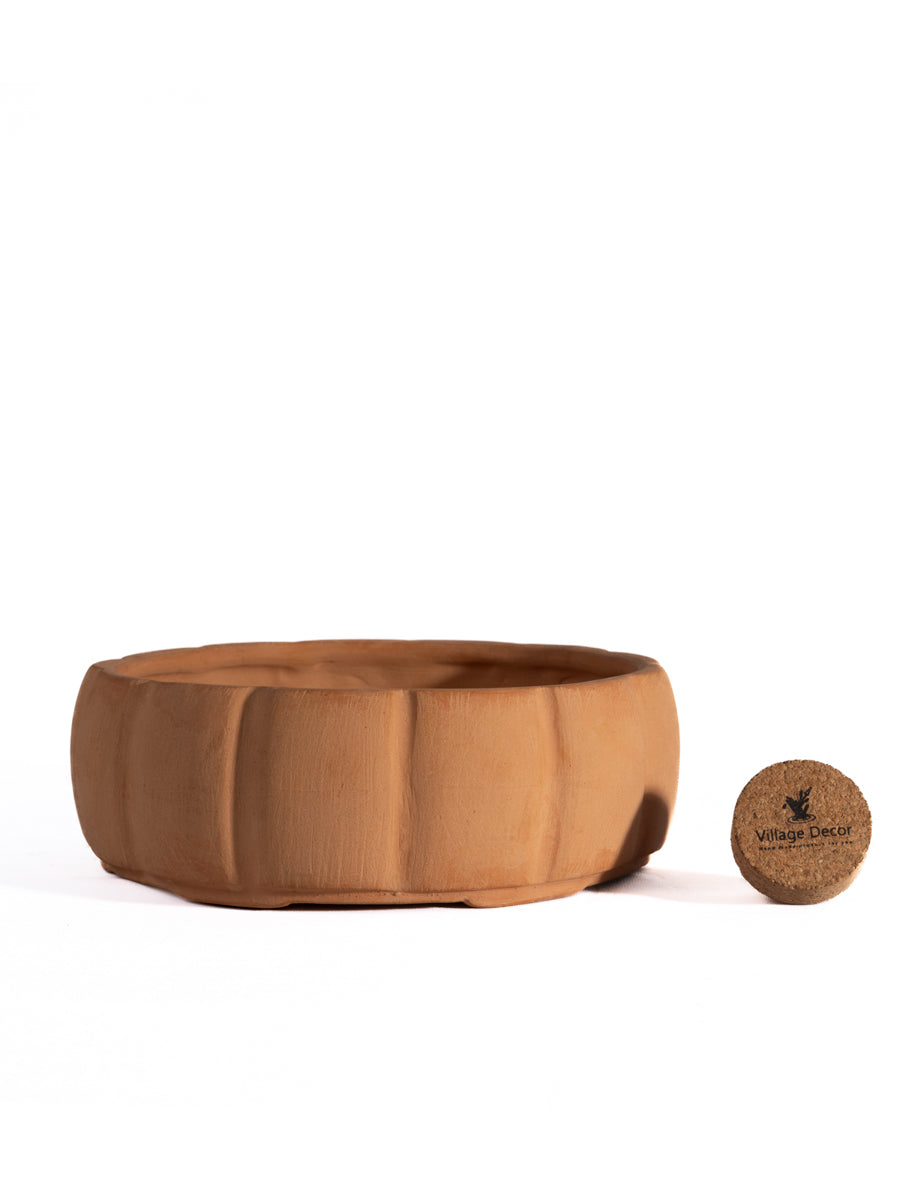 Round shape bonsai planter with white background view—perfect flower pot for indoor and garden spaces with a natural terracotta finish.
