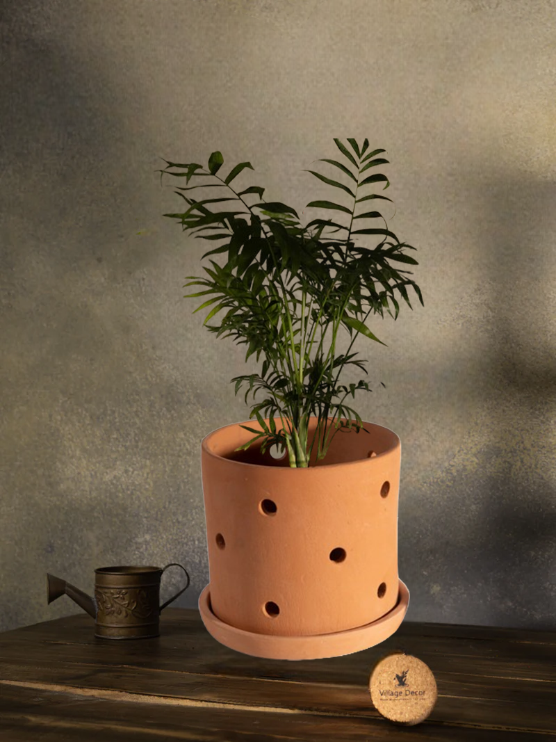 Terracotta indoor flower pot with multiple drainage holes, ideal for garden plants or as a decorative clay planter for home and office spaces.
