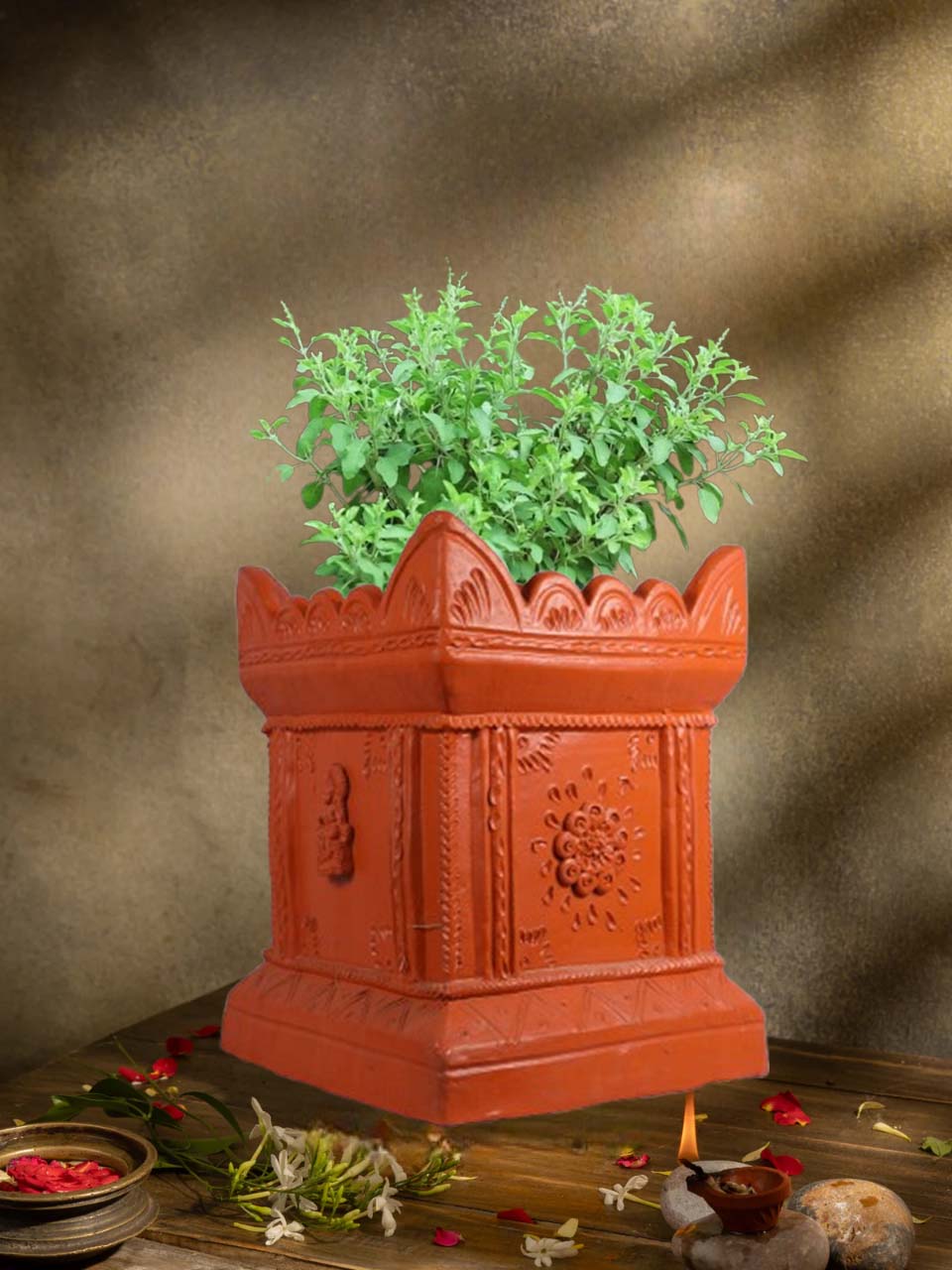 Handcrafted terracotta Tulsi Pot with Tulsi plant in traditional Vrindavan style, placed in a pooja setup with natural lighting and sacred decor.
