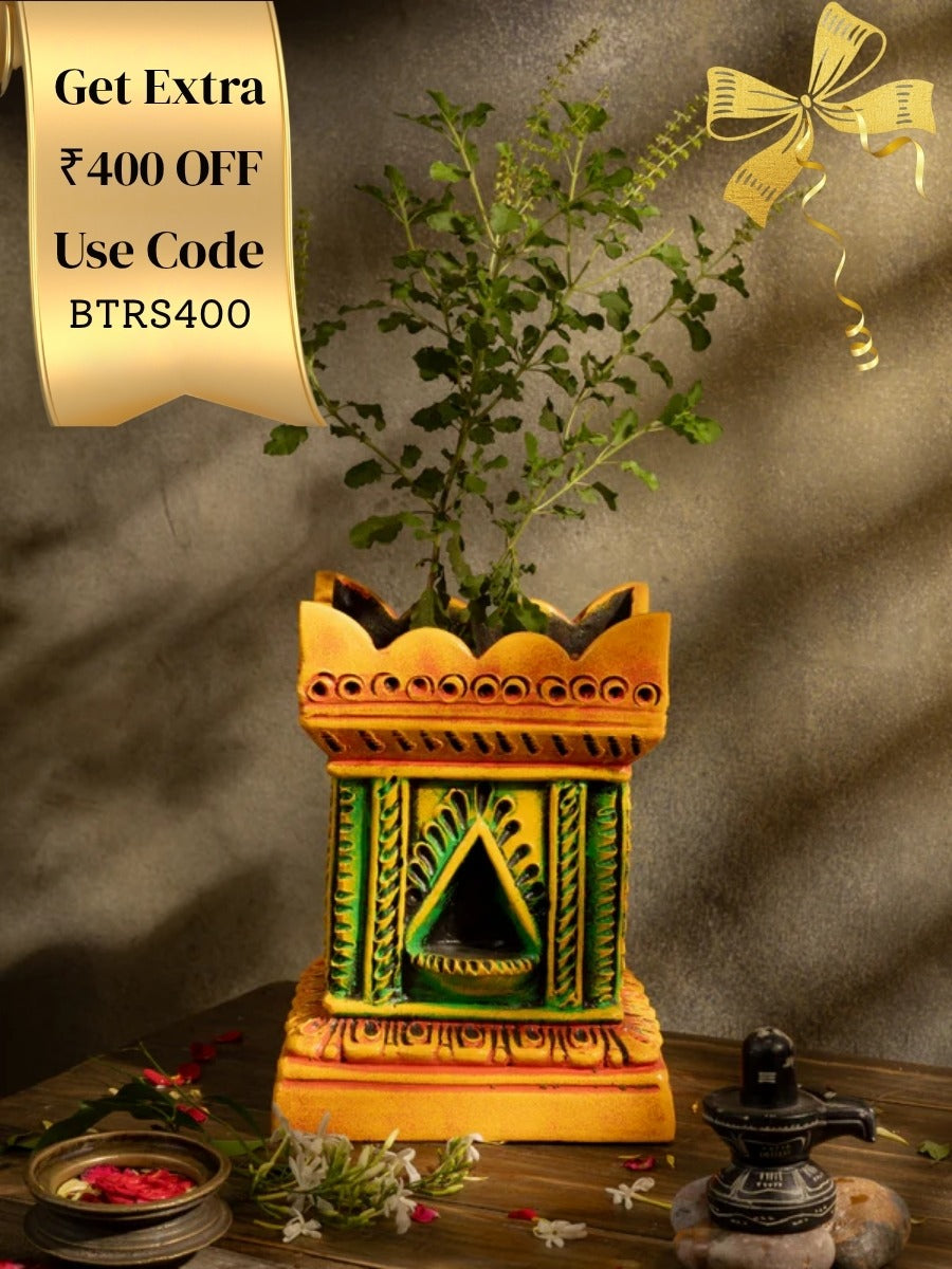 Handcrafted terracotta Tulsi Pot with Tulsi plant in traditional Vrindavan style, placed in a pooja setup with natural lighting and sacred decor.
