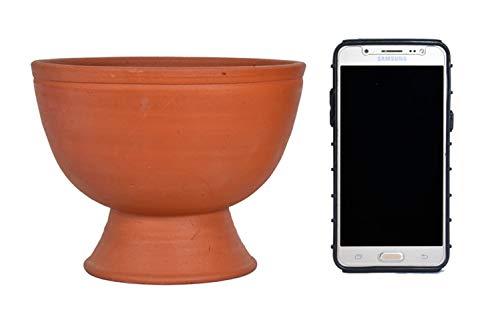 Terracotta clay garden pot placed beside a smartphone for size comparison, helping buyers visualize planter dimensions accurately.

